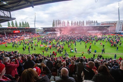 260425 - Wrexham v Charlton Athletic - Sky Bet League 1 - Wrexham fans celebrate promotion following the full time whistle