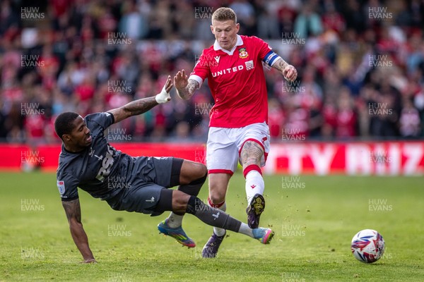 260425 - Wrexham v Charlton Athletic - Sky Bet League 1 - Tennai Watson of Charlton Athletic challenges James McClean of Wrexham AFC