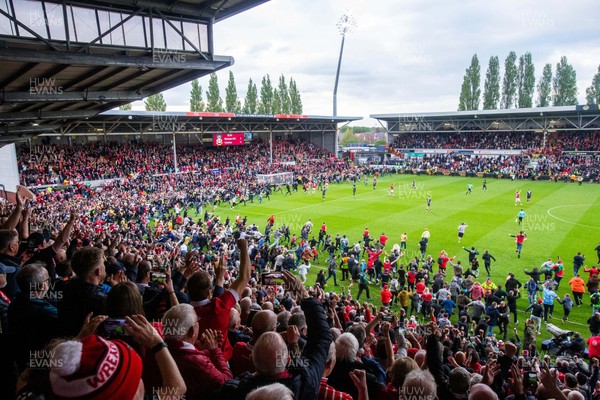 260425 - Wrexham v Charlton Athletic - Sky Bet League 1 - Wrexham fans celebrate at full time following their promotion securing victory over Charlton