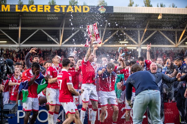 260425 - Wrexham v Charlton Athletic - Sky Bet League 1 - James McClean of Wrexham AFC lifts the Sky Bet League 1 promotion trophy following the victory over Charlton