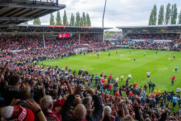260425 - Wrexham v Charlton Athletic - Sky Bet League 1 - Wrexham fans celebrate promotion following the full time whistle