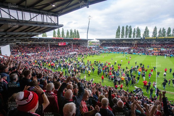 260425 - Wrexham v Charlton Athletic - Sky Bet League 1 - Wrexham fans celebrate promotion following the full time whistle