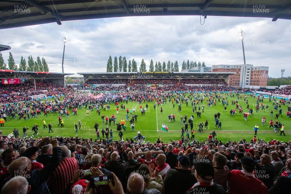 260425 - Wrexham v Charlton Athletic - Sky Bet League 1 - Wrexham fans celebrate promotion following the full time whistle