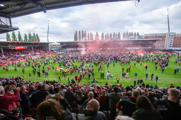 260425 - Wrexham v Charlton Athletic - Sky Bet League 1 - Wrexham fans celebrate promotion following the full time whistle