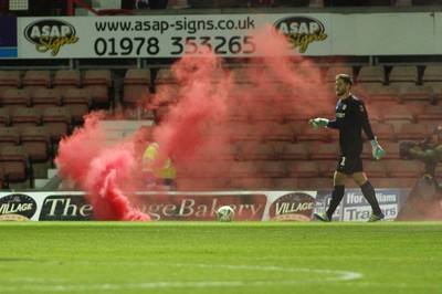 011218  Wrexham AFC v Newport County - Emirates FA Cup - Round 2 -  A flare is thrown onto the pitch near Joe Day of Newport County