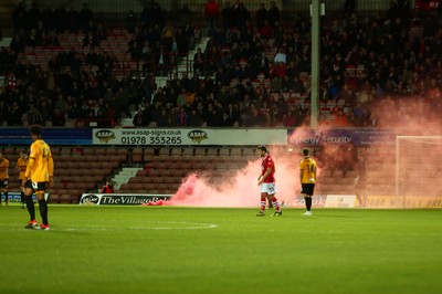 011218  Wrexham AFC v Newport County - Emirates FA Cup - Round 2 -  A flare is thrown onto the pitch near Joe Day of Newport County