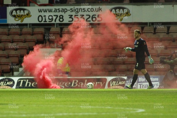 011218  Wrexham AFC v Newport County - Emirates FA Cup - Round 2 -  A flare is thrown onto the pitch near Joe Day of Newport County