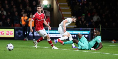 130326 - Wrexham v Swansea City - Sky Bet Championship - Marko Stamenic of Swansea shot saved by a kick from Goalkeeper Arthur Okonkwc of Wrexham