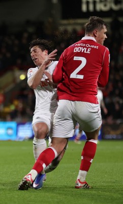 130326 - Wrexham v Swansea City - Sky Bet Championship - Goncalo Franco of Swansea collides with Callum Doyle of Wrexham