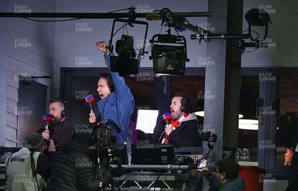 130326 - Wrexham v Swansea City - Sky Bet Championship - Wrexham owners Ryan Reynolds and Rob McElhenney celebrate Wrexham’s first goal in the gantry while broadcasting on Sky