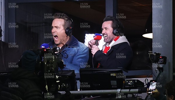 130326 - Wrexham v Swansea City - Sky Bet Championship - Wrexham owners Ryan Reynolds and Rob McElhenney celebrate Wrexham’s first goal in the gantry while broadcasting on Sky