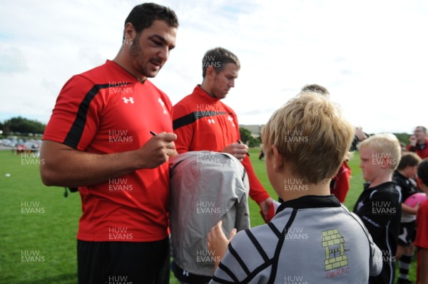 180813 - WRU - Admiral Festival of Rugby -Andries Pretorius, Ryan Jones and Gethin Jenkins sign young rugby players merchandise at the Admiral Festival of Rugby