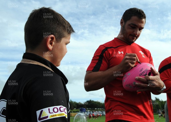 180813 - WRU - Admiral Festival of Rugby -Andries Pretorius signs a young rugby player's merchandise at the Admiral Festival of Rugby