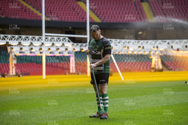 120417 - WRU Finals Day Media Preview - Principality Stadium groundsman and Caerphilly player Rhys Cleverly works on the pitch