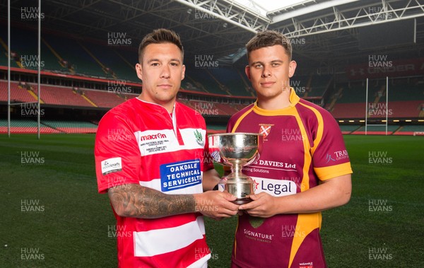240419 - WRU Finals Day Photocall - Keir Ennis, captain of Oakdale,  left, and Abergavenny captain Ieuan James whose teams will compete in the Bowl Final, during photocall with the trophy ahead of the match