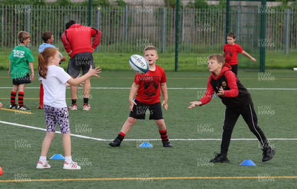 300823 - WRU Fit, Fed and Fun camp at Cardiff West High School - Children take part in a rugby skills and activities session at the Fit,Fed and Fun camp