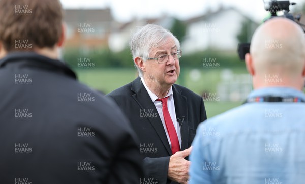 300823 - WRU Fit, Fed and Fun camp at Cardiff West High School - Welsh First Minister Mark Drakeford talks to media as children take part in a rugby skills and activities session at the Fit,Fed and Fun camp