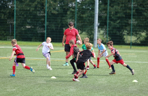 300823 - WRU Fit, Fed and Fun camp at Cardiff West High School - Children take part in a rugby skills and activities session at the Fit,Fed and Fun camp