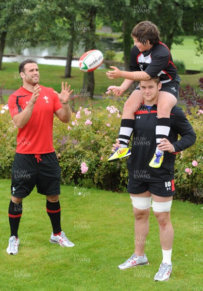 18.08.11 - WRU Junior Rugby Initiative Announcement - Jamie Roberts receives a pass from Pontyclun Under 11s captain Lloyd Evans as he gets a lift from Dan Lydiate. 