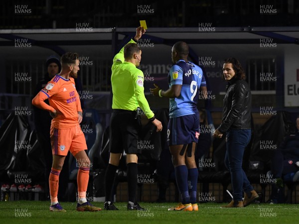 291220 - Wycombe Wanderers v Cardiff City - Sky Bet Championship - Uche Ikpeazu of Wycombe Wanderers is shown a yellow card by Referee Leigh Doughty as he slowly leaves the pitch