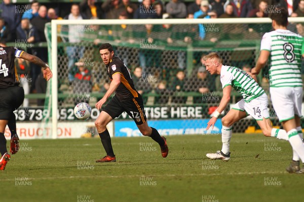 100318 - Yeovil Town v Newport County - EFL SkyBet League 2 - Ben Tozer of Newport County beats Sam Surridge of Yeovil Town to a loose ball 