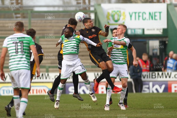 100318 - Yeovil Town v Newport County - EFL SkyBet League 2 - Joss Labadie (R) and Ben White of Newport County outjump Francois Zoko of Yeovil Town 