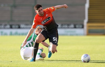 100718 - Yeovil Town v Swansea City - Pre Season Friendly - Cian Harries of Swansea City is tackled by Alex Fisher of Yeovil