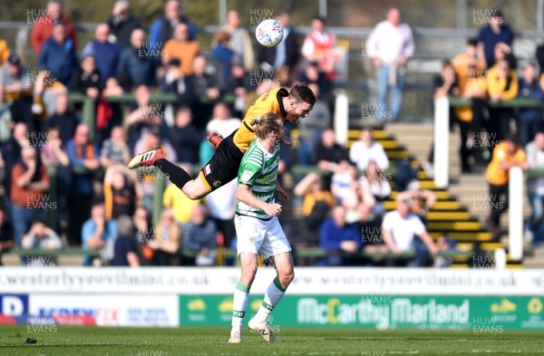 300319 - Yeovil v Newport County - SkyBet League 2 - Alex Fisher of Yeovil and Mark O'Brien of Newport County compete in the air