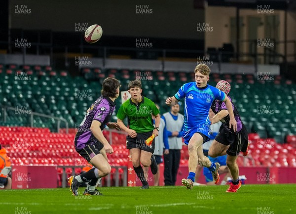 111225 - Ysgol Gymraeg Bro Morgannwg v Ysgol Gyfun Gymraeg Bro Myrddin - U18 Schools and Colleges Champions of Champions - Tomos Provis of Ysgol Gymraeg Bro Morgannwg kicks the ball past Rhys Jones of Ysgol Gyfun Gymraeg Bro Myrddin