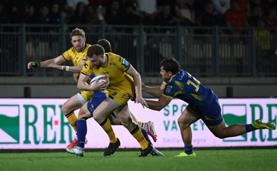 240426 - Zebre Parma v Dragons RFC - United Rugby Championship - Aneurin Owen of Dragons is tackled by Damiano Mazza of Zebre 