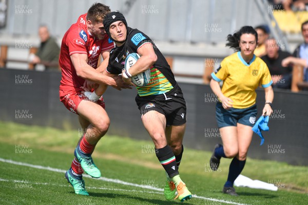 260322 - Zebre Parma v Scarlets - United Rugby Championship - Simone Gesi of Zebre is tackled by Scott Williams of Scarlets