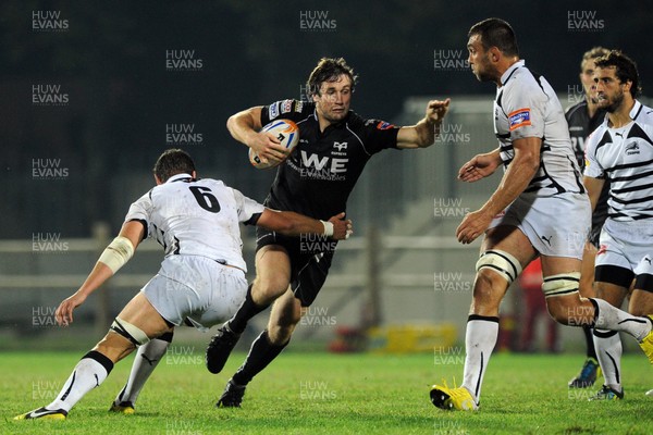 051012 Zebre v Ospreys - RaboDirect Pro12 - Ospreys' Andrew Bishop is tackled by Zebre's Emiliano Caffini 