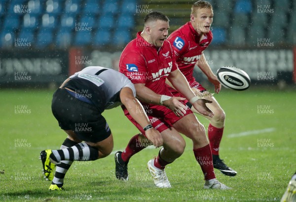 090917 - Zebre Rugby Club v Scarlets - Guinness PRO14 -  Rob Evans of Scarlets offloads the ball as he is tackled by Andrea Lovotti of Zebre